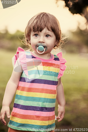 Image of little girl spending time at backyard