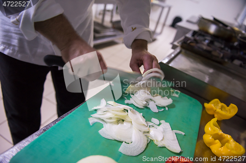 Image of Chef hands cutting fresh and delicious vegetables