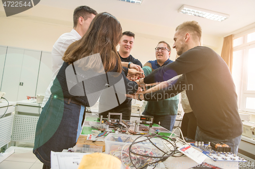 Image of students celebrating successfully finished project