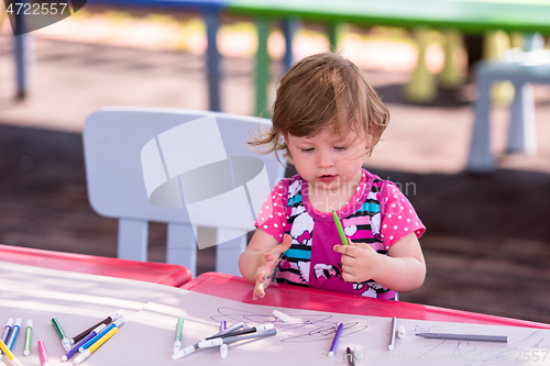 Image of little girl drawing a colorful pictures