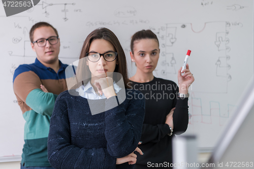 Image of portrait of young students in front of chalkboard