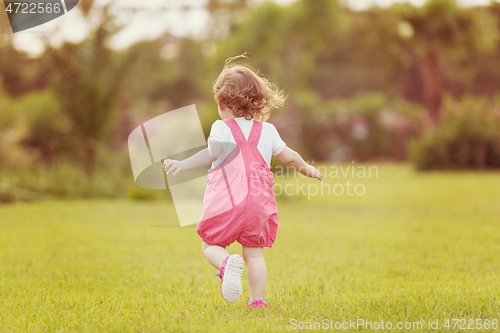 Image of little girl spending time at backyard