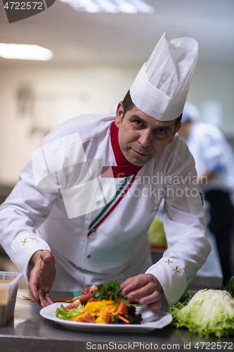 Image of chef serving vegetable salad