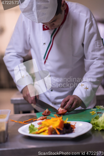 Image of chef serving vegetable salad