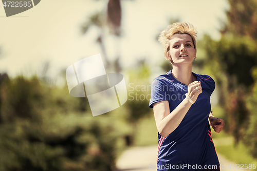 Image of young female runner training for marathon