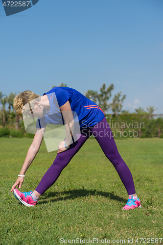 Image of female runner warming up and stretching