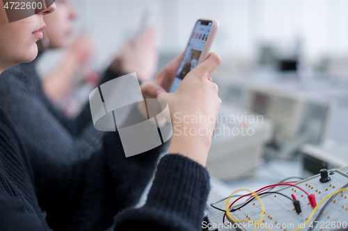 Image of female student using a mobile phone
