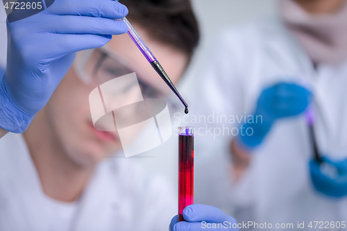 Image of student with protective glasses making chemistry experiment