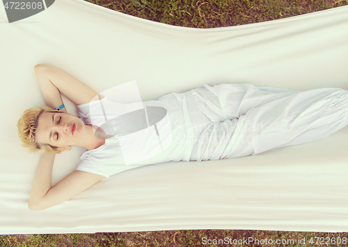 Image of young woman resting on hammock