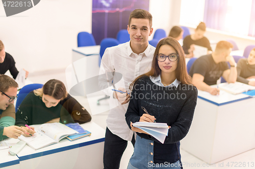 Image of young students writing notes