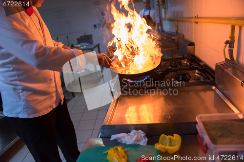 Image of Chef doing flambe on food