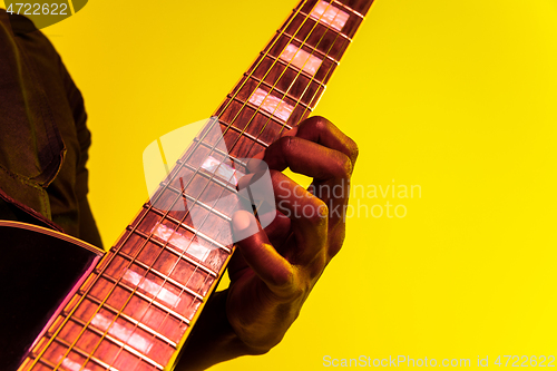 Image of Young african-american jazz musician playing the guitar