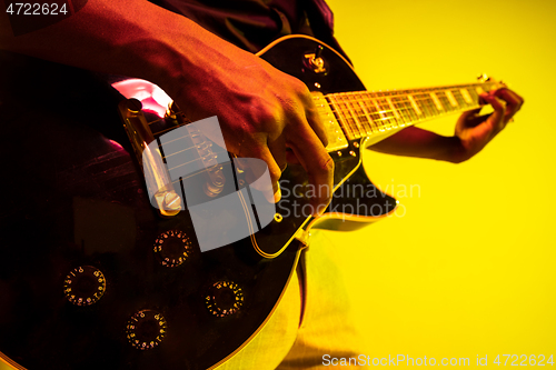 Image of Young african-american jazz musician playing the guitar