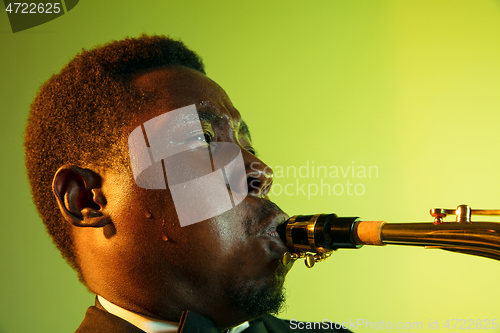 Image of Young african-american jazz musician playing the saxophone