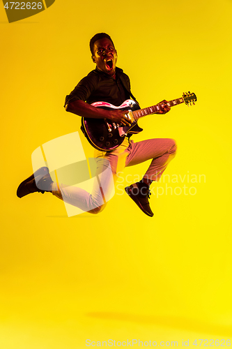 Image of Young african-american jazz musician playing the guitar