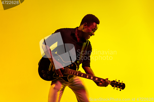 Image of Young african-american jazz musician playing the guitar