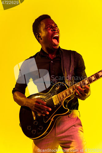 Image of Young african-american jazz musician playing the guitar