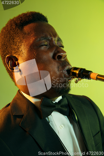 Image of Young african-american jazz musician playing the saxophone