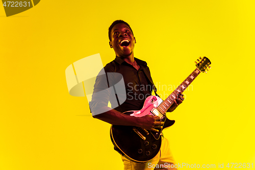 Image of Young african-american jazz musician playing the guitar