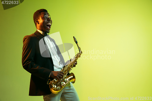 Image of Young african-american jazz musician playing the saxophone