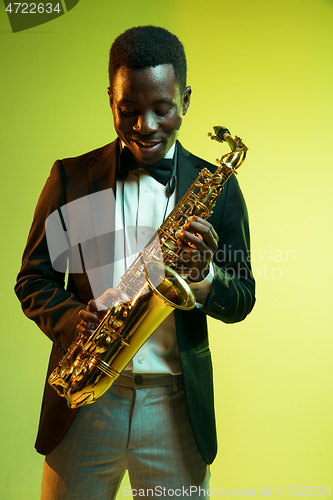 Image of Young african-american jazz musician playing the saxophone