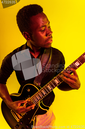 Image of Young african-american jazz musician playing the guitar