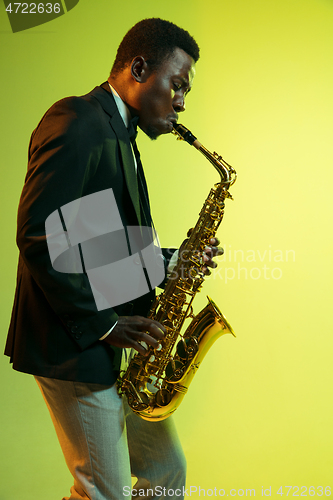 Image of Young african-american jazz musician playing the saxophone