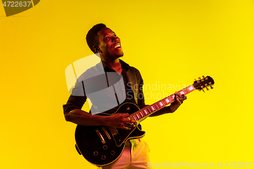 Image of Young african-american jazz musician playing the guitar