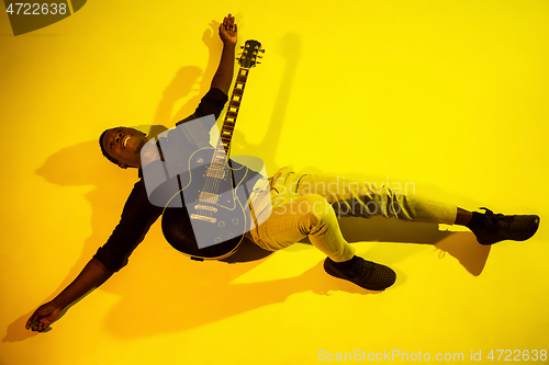 Image of Young african-american jazz musician playing the guitar