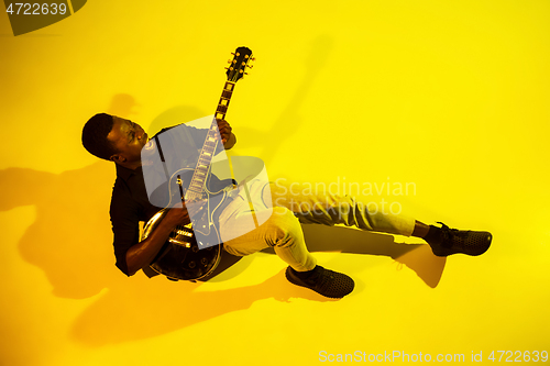 Image of Young african-american jazz musician playing the guitar