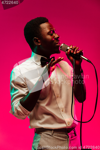 Image of Young african-american jazz musician singing a song