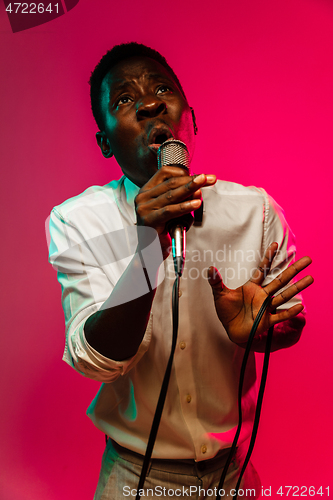 Image of Young african-american jazz musician singing a song