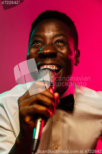 Image of Young african-american jazz musician singing a song