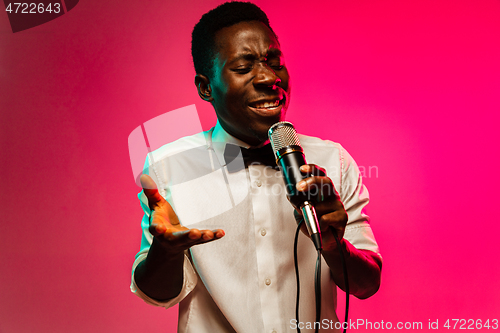 Image of Young african-american jazz musician singing a song