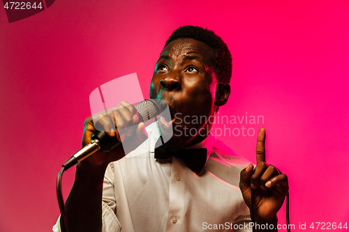 Image of Young african-american jazz musician singing a song