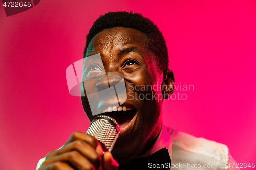 Image of Young african-american jazz musician singing a song