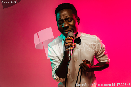 Image of Young african-american jazz musician singing a song