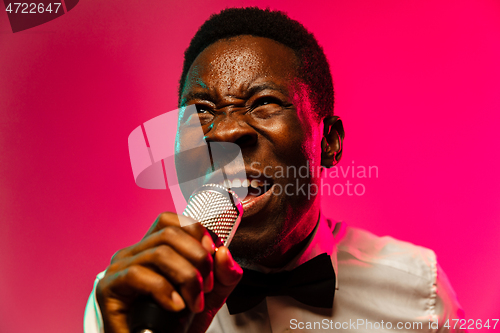 Image of Young african-american jazz musician singing a song