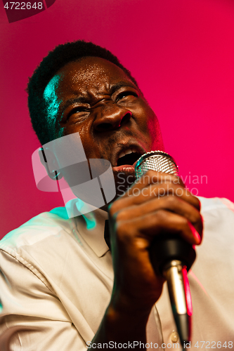 Image of Young african-american jazz musician singing a song