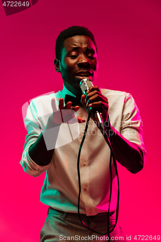 Image of Young african-american jazz musician singing a song