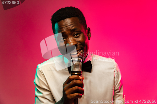 Image of Young african-american jazz musician singing a song