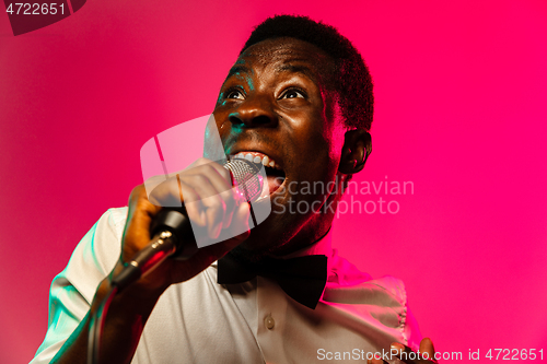 Image of Young african-american jazz musician singing a song