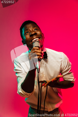 Image of Young african-american jazz musician singing a song