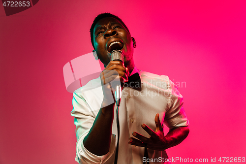 Image of Young african-american jazz musician singing a song