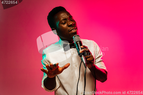 Image of Young african-american jazz musician singing a song