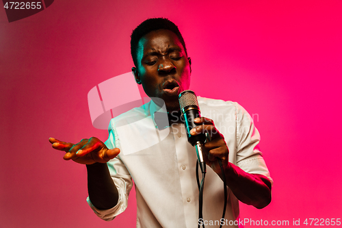 Image of Young african-american jazz musician singing a song