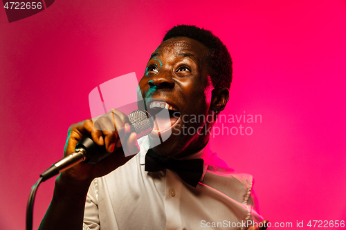 Image of Young african-american jazz musician singing a song