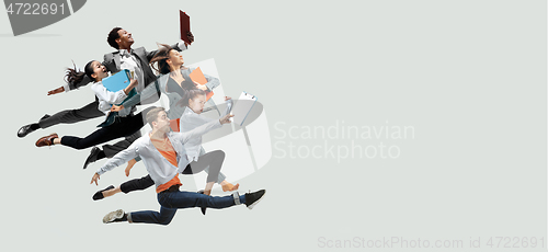 Image of Office workers jumping isolated on studio background