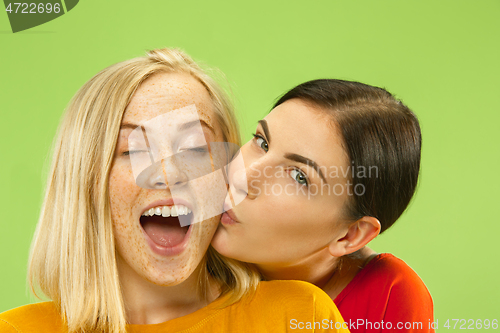 Image of Portrait of pretty girls isolated on green studio background