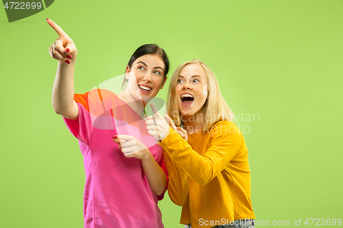 Image of Portrait of pretty girls isolated on green studio background